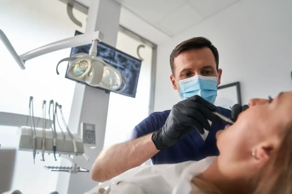Le dentiste perce les dents du patient